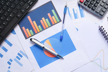 Top view of financial chart and pens on table 