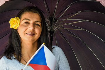 Sticker -  Woman with umbrella holds flag of Czech Republic in front of isolated wall background