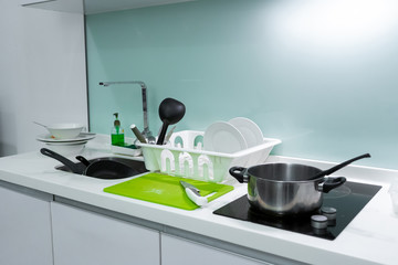 Wall Mural - A mountain of dirty dishes in the kitchen sink. Mess in the house