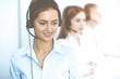 © rogerphoto - Call center. Focus on beautiful business woman in headset