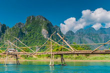 Bamboo Bridge Crossing The Nam Song River With A Beautiful Mountain Backdrop Near Vang Vieng, Laos 