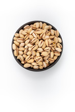 Roasted Salty Pistachios  In Round Bowl On White Background, Top View