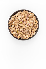 Roasted Salty Pistachios  In Round Bowl On White Background, Top View