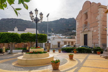 Poster - Streets of a white town called Lucainena de las Torres in Spain. Some flowers and balconies.