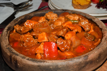 Wall Mural - Home cooked lamb and beef or pork stew, served in a traditional restaurant, in wooden bowl