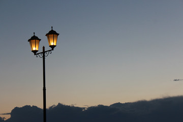 Two lamps against the sky with clouds