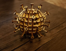The Image Of A Coronavirus Particle Made Of Wood. Woodcraft Coronavirus. Wooden Virus. Woodcraft Art. Covid-19
