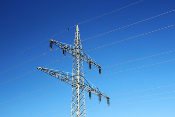 Electricity cable lines against bright blue sky