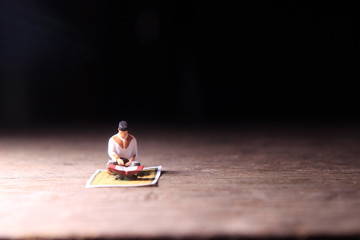 Wall Mural - Conceptual Photo, Sitting Muslim, Islam People Reading Al Quran, at Wooden Floor