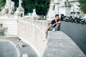 Nice boy posing in Rome during a sunny day untile the sunset