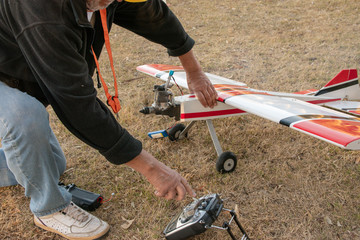 Wall Mural - The man starts the engine on the aircraft model