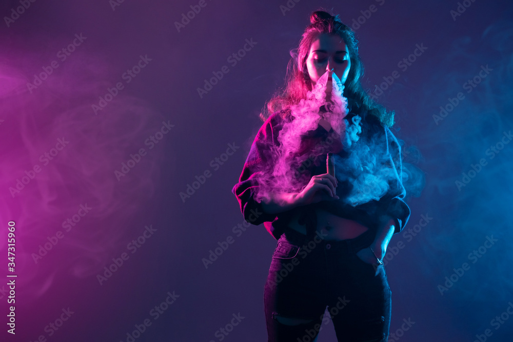 Vape. Vaper. Vaping. Girl exhales smoke through her nose. Vaper blows steam  from his nose. Woman