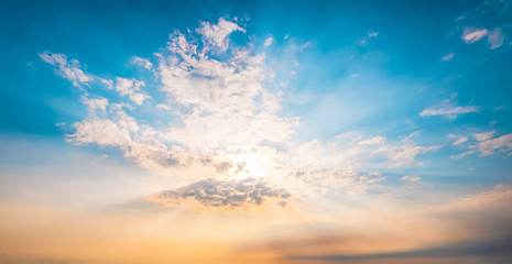 Wall Mural - yellow sunlight of the sun through the clouds over the blue sky. sunshine in morning. nature backgro