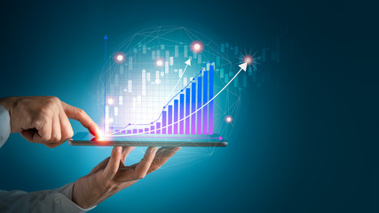 Businessman using tablet and technology. Digital marketing of Sales and Economic growth graph chart.