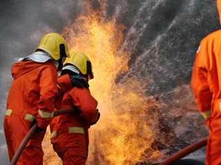 Poster - firefighter spray water to fire burning car workshop fire training