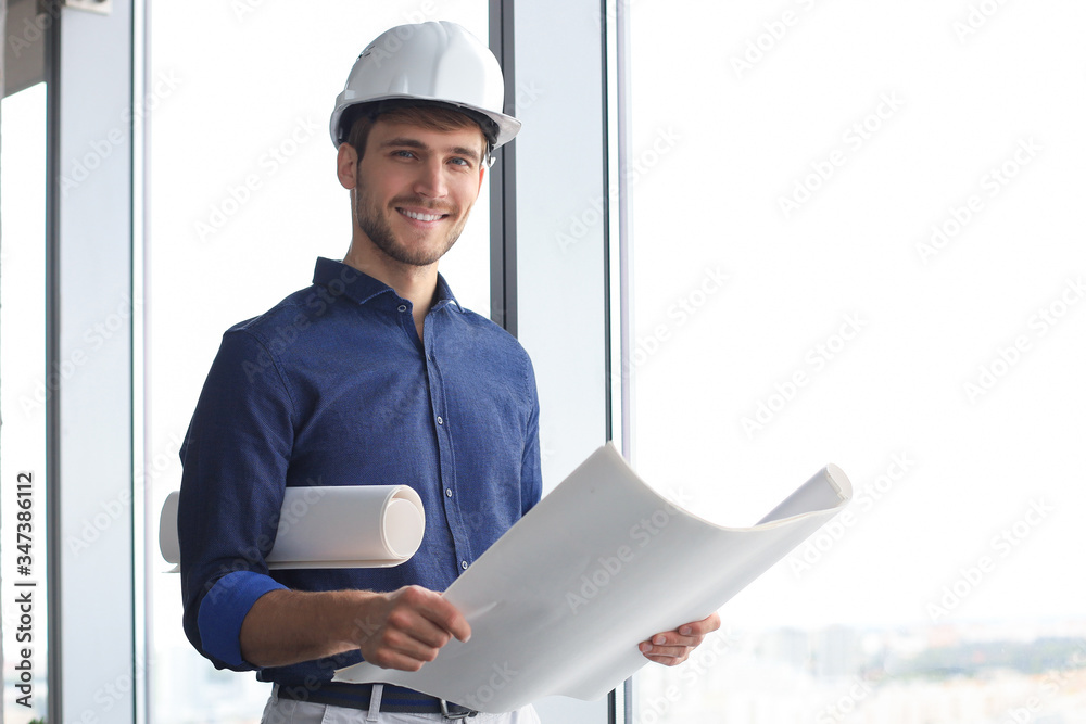 Shot of male architect wearing hardhat and inspecting new building. - obrazy, fototapety, plakaty 