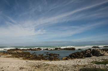 Wall Mural - rocky beach and cloudy sky south africa