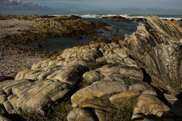 Wall Mural - rocky beach and cloudy sky south africa