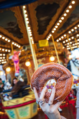 Wall Mural - A sugary donut in front of an ancient German Horse Carousel built in 1896 in Navona Square, Rome, Italy