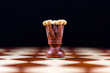 black chess king on a chessboard on a black background