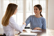 © fizkes - Happy young female patient shake hand of good woman doctor closing deal making health insurance agreement, smiling client handshake physician get acquainted greeting at consultation in clinic