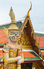 Guard sculpture at Wat Arun Tample with golden surface in Bangkok background