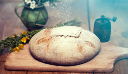 Freshly baked traditional bread on wooden table