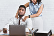 No to sexual harassment. African American lady making shoulder massage to her annoyed colleague at workplace