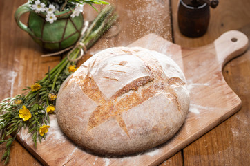 Freshly baked traditional bread on wooden table