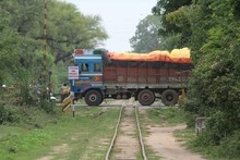 Semi-truck Crossing Railroad Track Amidst Trees