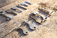 Overhead Of Many Different Keys In Oder On Wooden Background Concept