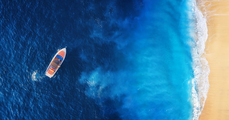 Wall Mural - seascape with beach and boat. yachts at the sea surface. aerial view of luxury floating boat on blue