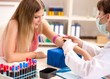 © Elnur - Young beautiful woman during blood test sampling procedure