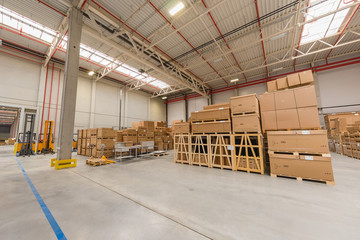 warehouse loading cardboard boxes by forklift stacker loader