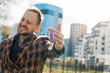 ©  drugoenebo - A joyful young man shows the keys to the apartment. concept of buying real estate