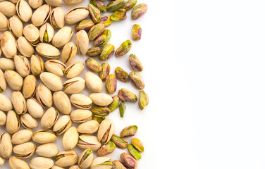 roasted pistachio nuts on a white background and place for inscription