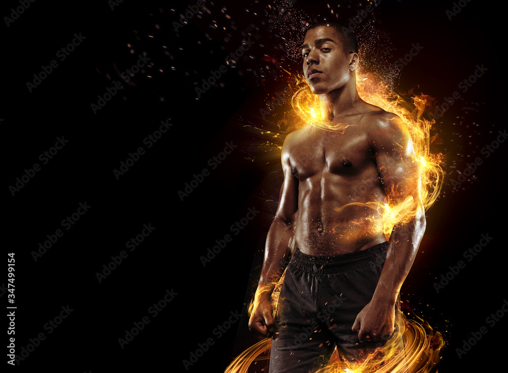 Sport. Dramatic portrait of professional athlete. Winner in a competition. Fire and energy. - obrazy, fototapety, plakaty 