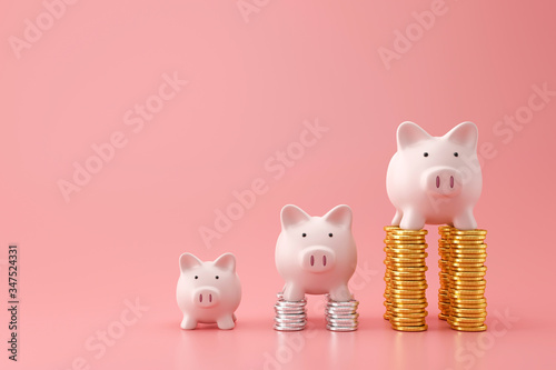 Photographie Piggy bank and golden stack coins of three level graph on pink background with saving money concept