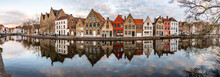 Panorama With Buildings With Reflections  Around Channels In Bruges At Sunset