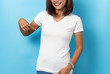 © suriya - Portrait of asian woman in a blank white T-shirt on blue background Mock-up