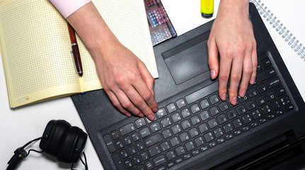 Poster - Female hands is tyoing on keyboard with notebooks, pens around. Online business