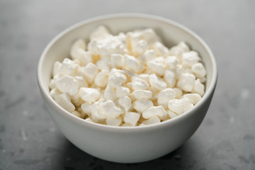 Sticker - Cottage cheese in white bowl on concrete background