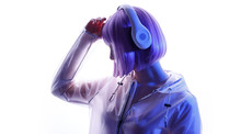 Beautiful Woman With Purple Hair In Futuristic Costume Over White Background. Blue And Violet Neon Light. Portrait Of Young Girl In Modern Headphones Listening Music. Free Space For Text.