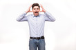 © F8  \ Suport Ukraine - Young man screaming mouth open, hold head hand, wear casual blue shirt, isolated white background.