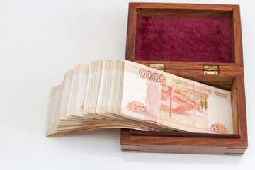 Russian banknotes of five thousand rubles in large quantities in a wooden box