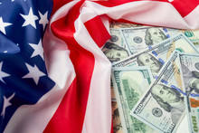 Close Up Of American Flag And Dollar Cash Money. Dollar Banknote And United States Flag Background. Economy Of USA