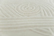 © strigana - Zen garden. Pyramids of white and gray zen stones on the white sand with abstract wave drawings. Concept of harmony, balance and meditation, spa, massage, relax.