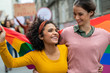 © Rido - Lesbian couple at gay pride with rainbow flag