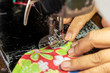 © kaentian - A close up, sewing the fabric on the old machine.
