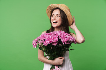 Sticker - Image of cheerful woman in straw hat laughing and holding flowers